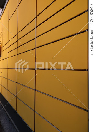 A yellow wall with a row of yellow boxes A yellow wall with a row of yellow boxes 126085840