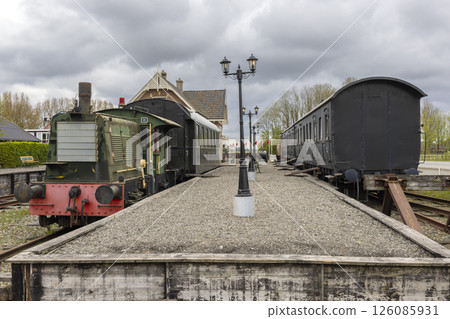Vintage train resting on tracks in a cloudy day in Marrum, Friesland, Netherlands Vintage train resting on tracks in a cloudy day in Marrum, Friesland, Netherlands 126085931