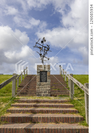 Monument with farming tools rising above brick stairs in Wierum, Friesland, Netherlands 126085934