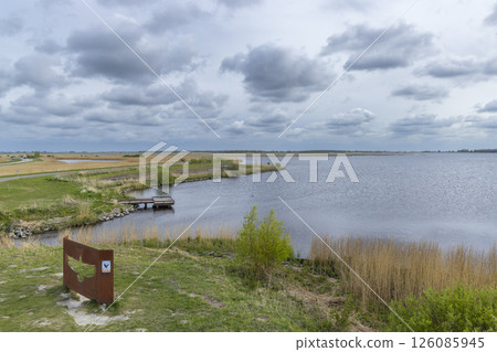 Birdwatching spot overlooking peaceful lake Lauwersmeer in Lauwersoog National Park, Netherlands Birdwatching spot overlooking peaceful lake Lauwersmeer in Lauwersoog National Park, Netherlands 126085945