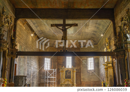 Interior view of the wooden gothic church with Jesus Christ on the cross hanging from the ceiling Interior view of the wooden gothic church with Jesus Christ on the cross hanging from the ceiling 126086039