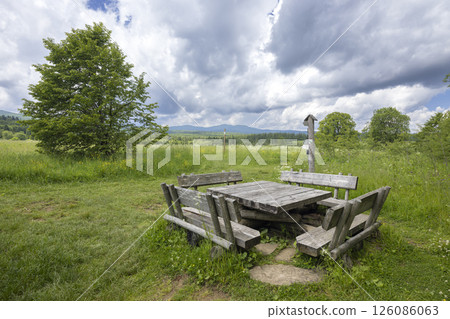 Wooden table and benches inviting hikers to rest in the Bieszczady Mountains, Poland Wooden table and benches inviting hikers to rest in the Bieszczady Mountains, Poland 126086063