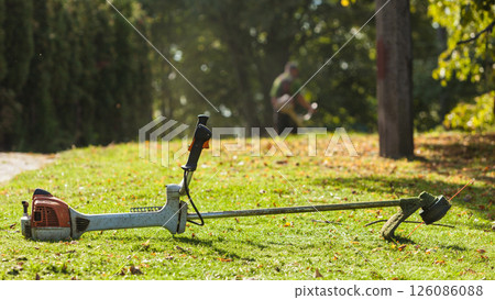 Mower brushcutter on green grass Mower brushcutter on green grass 126086088