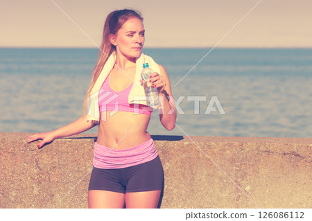 Woman drinking water after sport gym outdoor Woman drinking water after sport gym outdoor 126086112