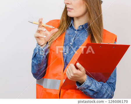Woman engineer construction builder holds file pad. Woman engineer construction builder holds file pad. 126086170