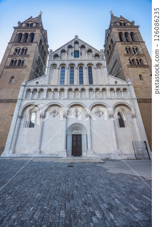 Cathedral in Pecs town in Hungary, Europe. Imposing cathedral facade with towering twin bell towers, showcasing intricate architecture and historical significance. Cathedral in Pecs town in Hungary, Europe. Imposing cathedral facade with towering twin bell towers, showcasing intricate architecture and historical significance. 126086235