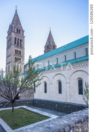 Cathedral in Pecs town in Hungary, Europe. Historic edifice stands tall against the sky, exhibiting architectural grandeur and religious significance. The structure exudes timeless elegance. Cathedral in Pecs town in Hungary, Europe. Historic edifice stands tall against the sky, exhibiting architectural grandeur and religious significance. The structure exudes timeless elegance. 126086260
