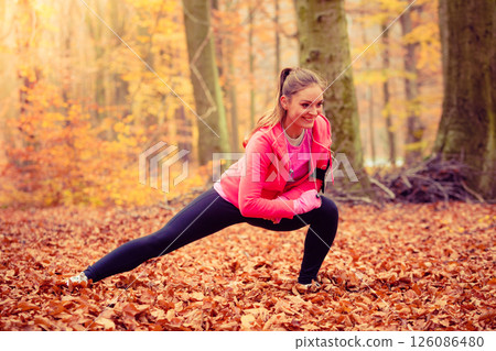 Fit girl doing stretching outdoor. 126086480
