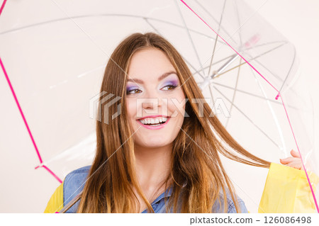 Woman wearing waterproof coat under umbrella Woman wearing waterproof coat under umbrella 126086498