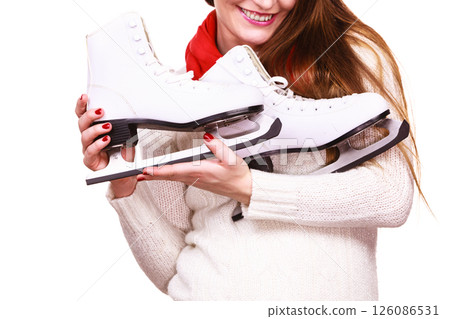 Smiling woman with ice skates Smiling woman with ice skates 126086531