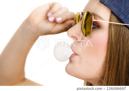 Funky girl blowing balloon. Funky girl blowing balloon. 126086697