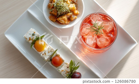 Stylish cocktail accompanied by a gourmet appetizer plate showcasing paired flavors and vibrant colors, snacktail concept Stylish cocktail accompanied by a gourmet appetizer plate showcasing paired flavors and vibrant colors, snacktail concept 126086780
