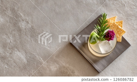 Savory snack and gourmet cocktail pairing presented on a chic bar table with neutral tones and accents, snacktail concept 126086782
