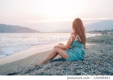 Woman in Flowing Dress on Seaside Pier 126086961