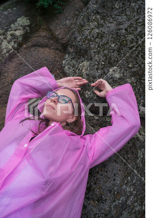 Woman in the taiga forest and rocks of the Stolby nature reserve park 126086972