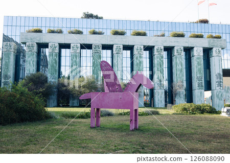 Pink winged horse sculpture in modern urban setting 126088090