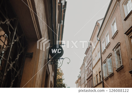 WC toilet sign hanging on historic street in Warsaw 126088122