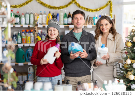 Family shopping for laundry detergent in Christmas decorated store 126088135