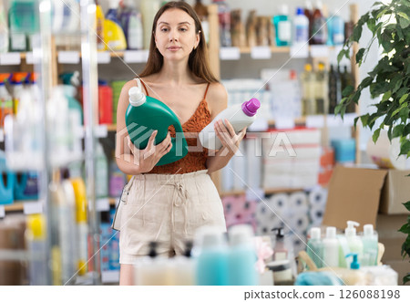 Young woman choosing fabric softener in household goods store 126088198