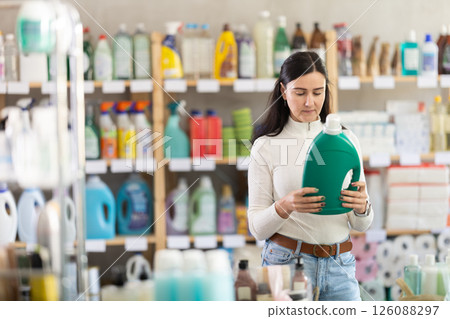 customer in a Spanish supermarket chooses detergent customer in a Spanish supermarket chooses detergent 126088297