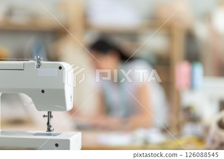 Sewing machine on background of sewing workshop close-up Sewing machine on background of sewing workshop close-up 126088545