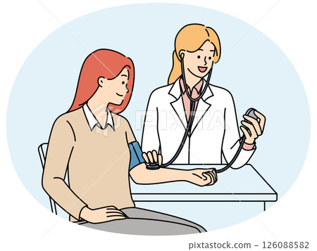 Woman undergoes medical examination at doctor using device for measuring pressure 126088582