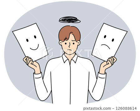 Man holds two sheets of paper with different emotions symbolizing mood swings 126088614