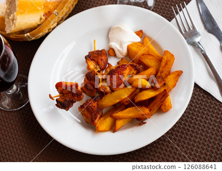 Fried chicken kebab served with potatoes 126088641