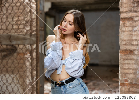 Portrait of young desirable woman in abandoned building 126088808