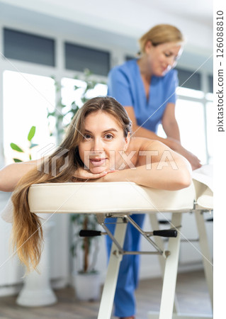 Massage therapist makes massage 126088810