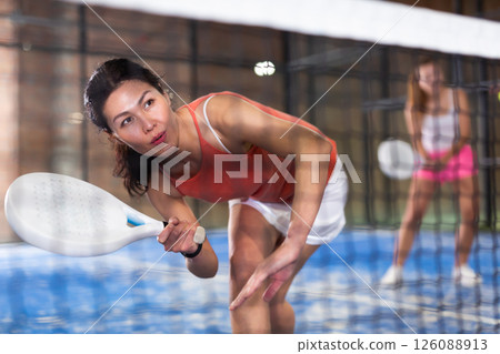 Asian girl with passion play padel closeup Asian girl with passion play padel closeup 126088913