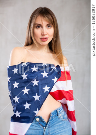 Young woman wrapped in USA flag Young woman wrapped in USA flag 126088917