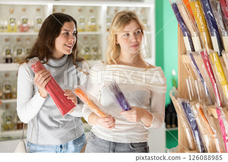 Girl friends client chooses aroma sticks, inhales fragrance Girl friends client chooses aroma sticks, inhales fragrance 126088985