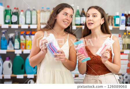 Two girls friends choose disposable razor in household shop 126089068