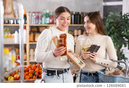 Women choose Spanish sweets in the store Women choose Spanish sweets in the store 126089081