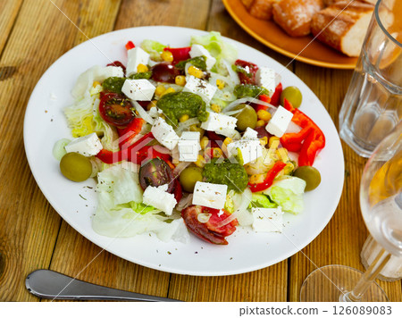 Portion of fresh salad served on table Portion of fresh salad served on table 126089083