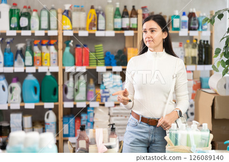 woman chooses household chemicals in a supermarket 126089140