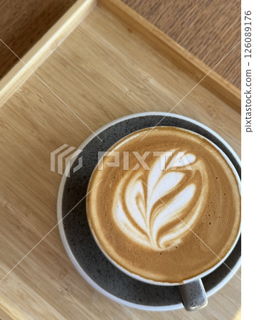 A cup of hot latte coffee on a wooden table taken using a high angle cafeine breakfast  126089176