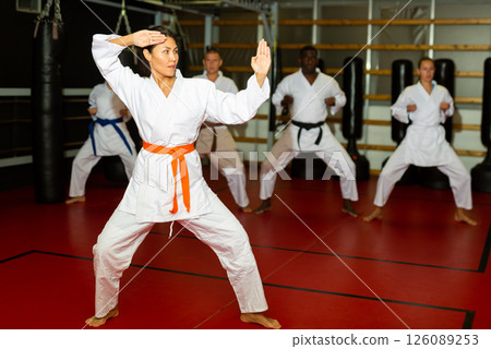 Woman in kimono standing in fight stance in gym 126089253