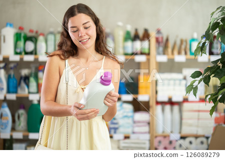 Woman consumer with household chemical products for washing indoors Woman consumer with household chemical products for washing indoors 126089279