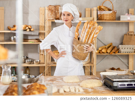 Positive female seller showing assortment of bakery Positive female seller showing assortment of bakery 126089325