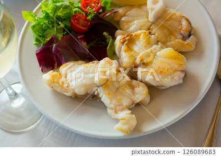 Baked pieces of monkfish 126089683