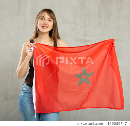 Young happy pretty woman displaying flag of morocco Young happy pretty woman displaying flag of morocco 126089747