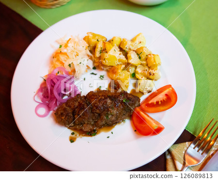 Plate with a meat dish lula-kebab and stewed potatoes. 126089813