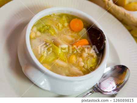 Bean's catalan soup with carrots and potatoes, served with black sausage 126089815