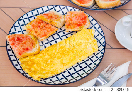 Fried rolled omelette with toast and vegetable sauce 126089856