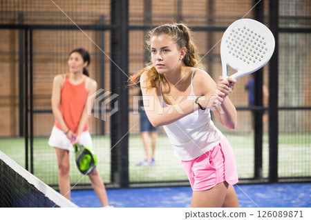 Woman playing padel tennis on padel court Woman playing padel tennis on padel court 126089871