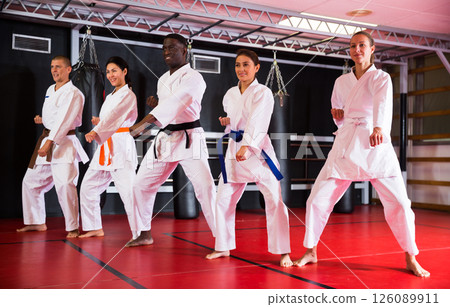 Multiracial group of people doing kata moves in gym 126089911