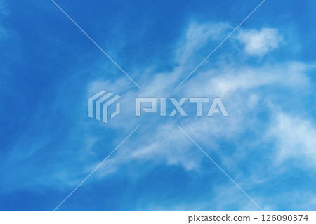 A photo of a blue sky with small diffused translucent clouds, dispersed by the wind and opening up space. Movement of air currents in nature above the ground A photo of a blue sky with small diffused translucent clouds, dispersed by the wind and opening up space. Movement of air currents in nature above the ground 126090374