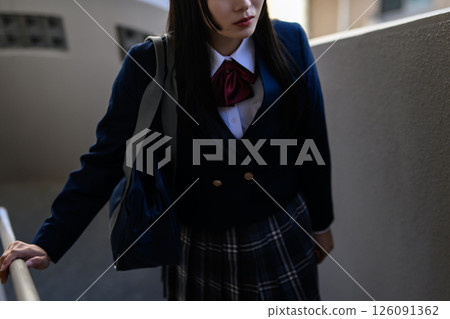High school girl climbing the stairs, becoming an adult, blazer, light and dark trimming High school girl climbing the stairs, becoming an adult, blazer, light and dark trimming 126091362